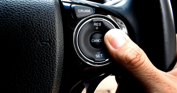A driver's thumb on cruise control