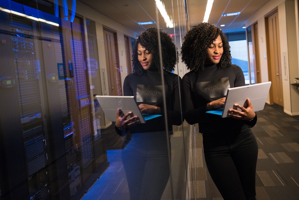 woman standing with laptop